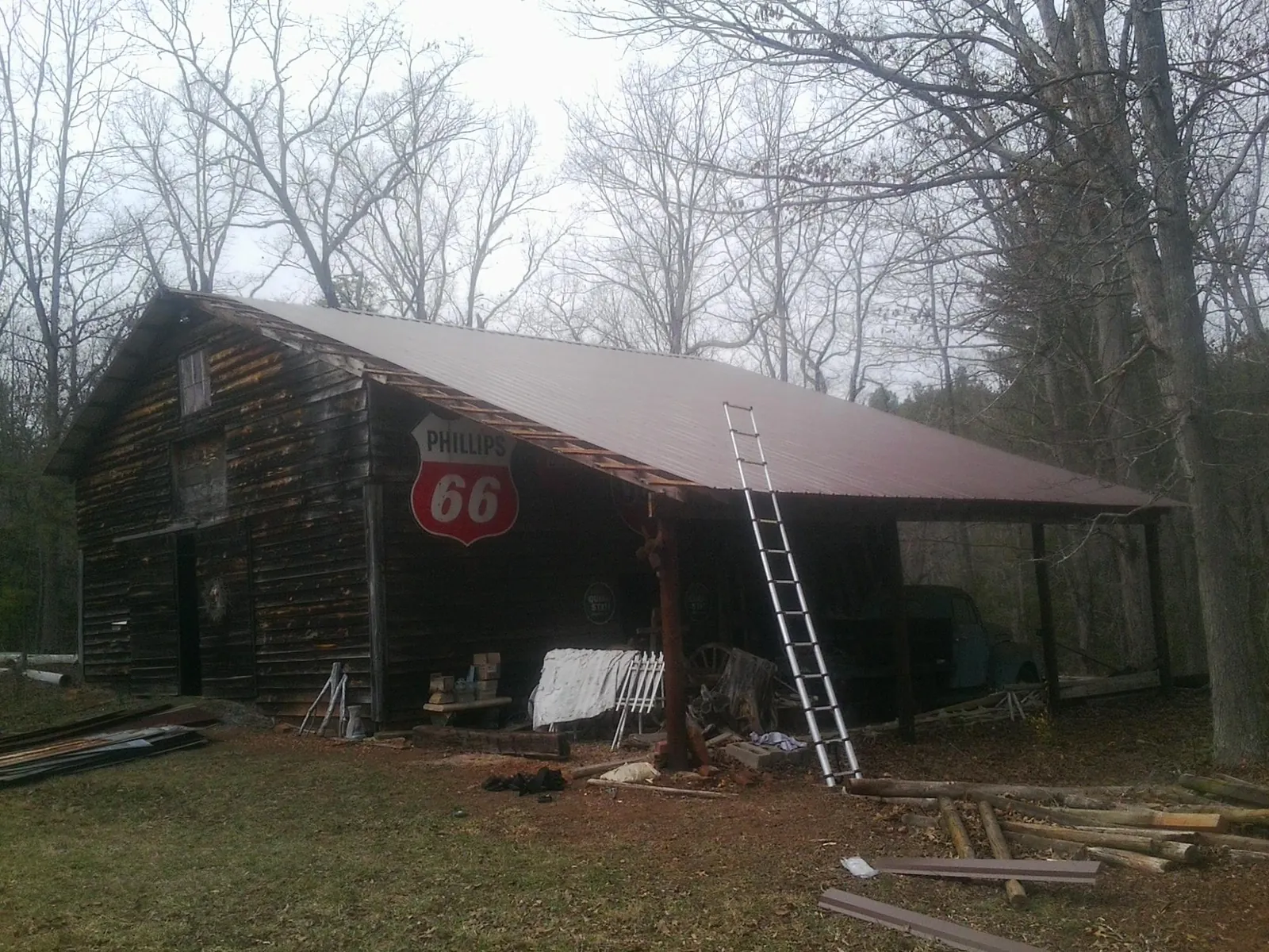 New metal roof on an open sided timber barn with a vintage sign in Maplewood